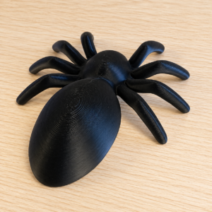 Ragno decorativo nero stampato in 3D da PixThinkLab, con otto zampe